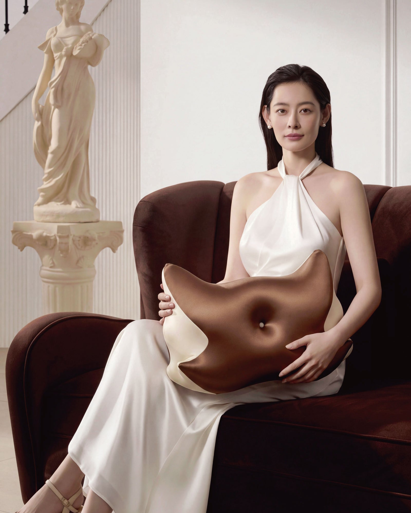 Brown contoured pillow in a seated product presentation