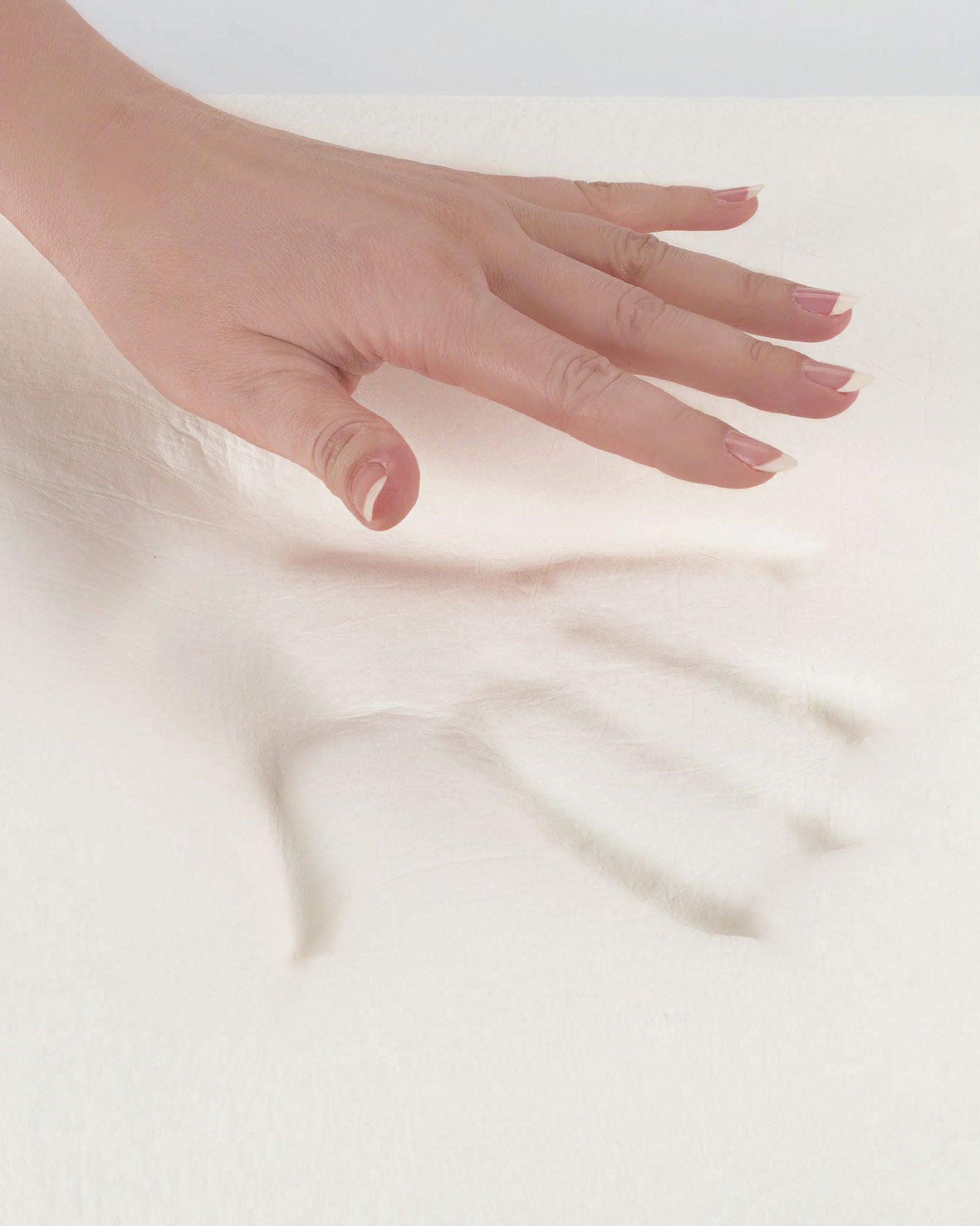 Close-up of a hand demonstrating memory foam feel