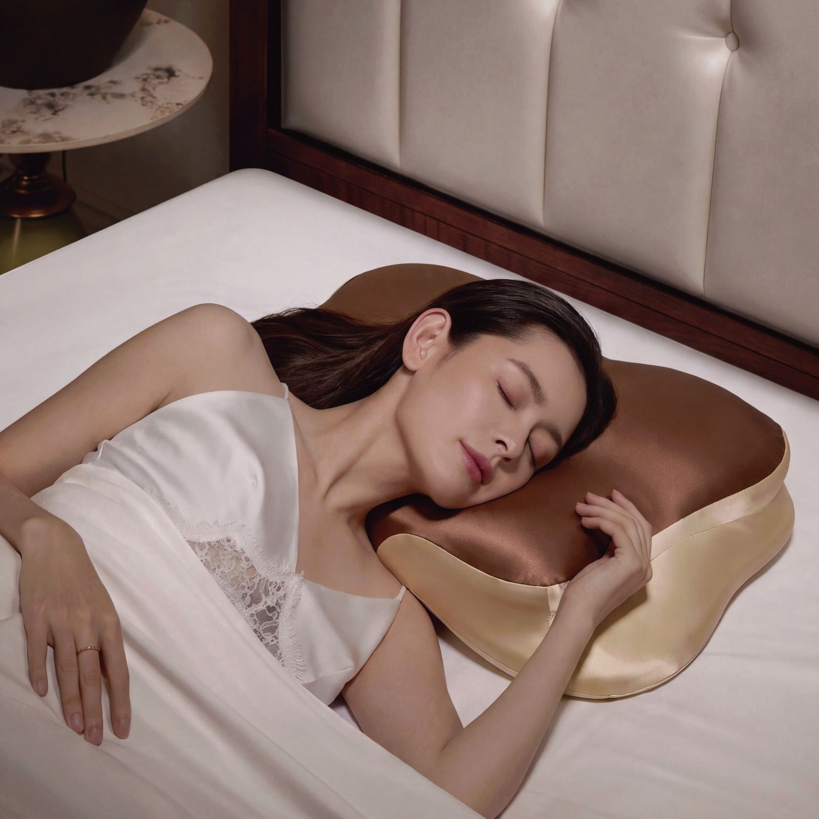 Brown contoured pillow shown in a bedroom setting
